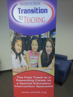 Picture of 6 foot high TTT promotional poster. Teacher and two students